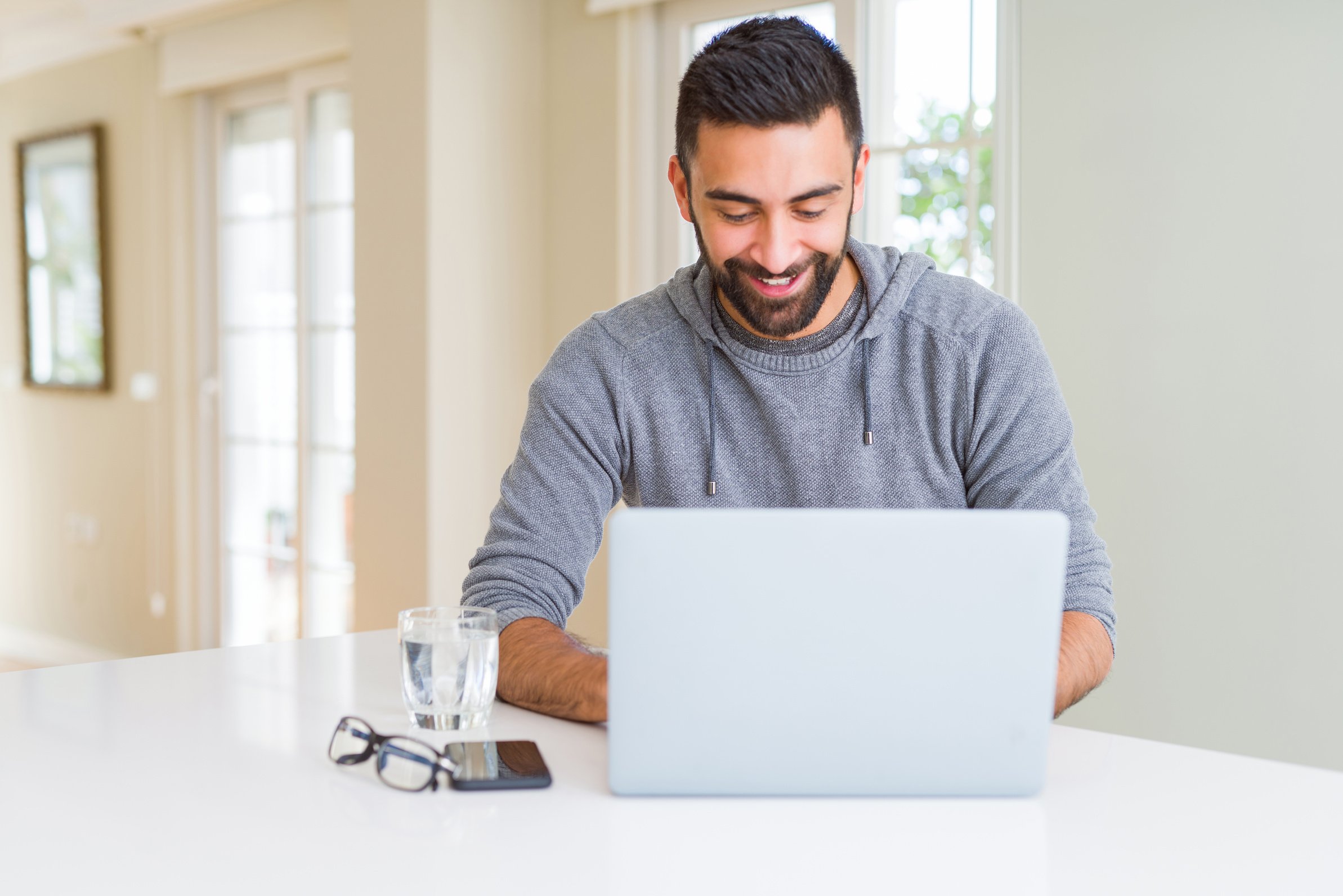 Man smiling working using computer laptop